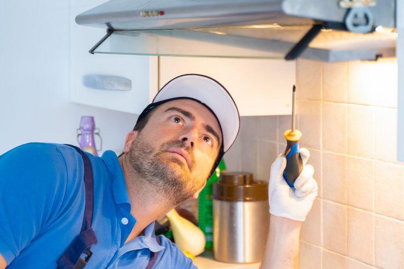 Technician Performing Hood Inspection